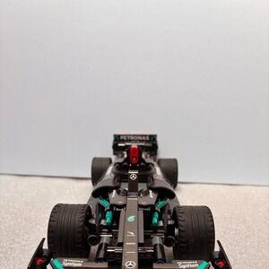 Mercedes F1 car model with green accents and Petronas
